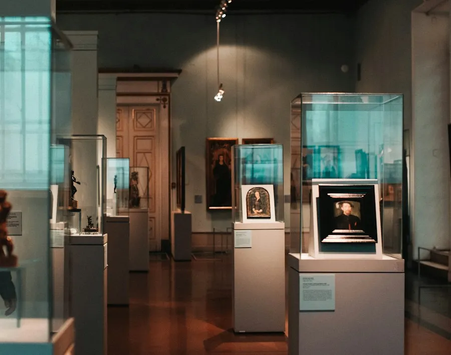 Quiet museum gallery with framed paintings in illuminated display cases
